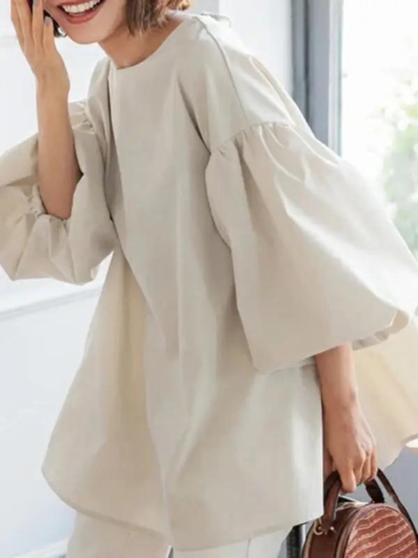 Close-up of beige lantern sleeve shirt