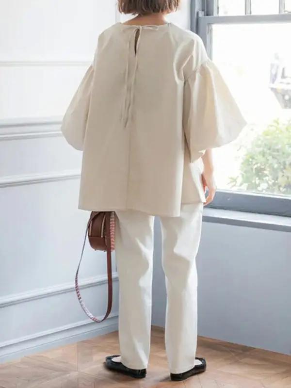 Back view of beige lantern sleeve shirt