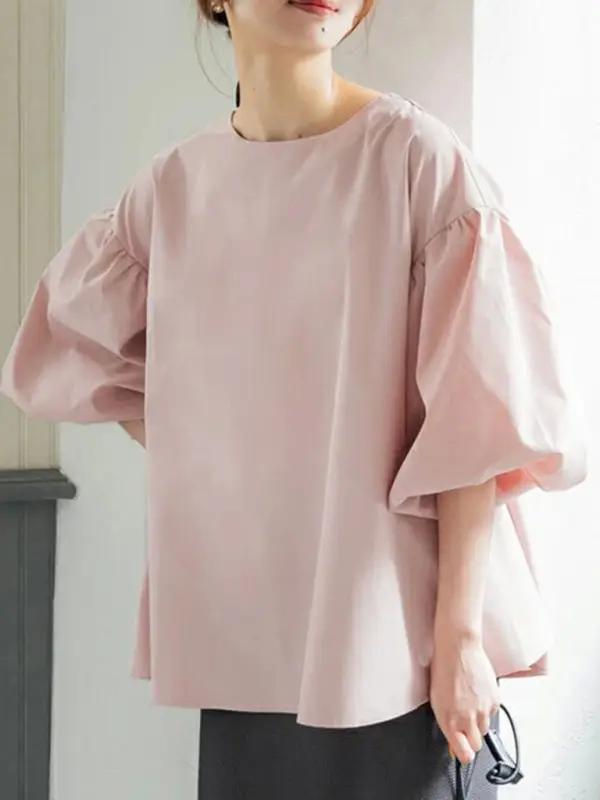 Close-up of pink lantern sleeve shirt