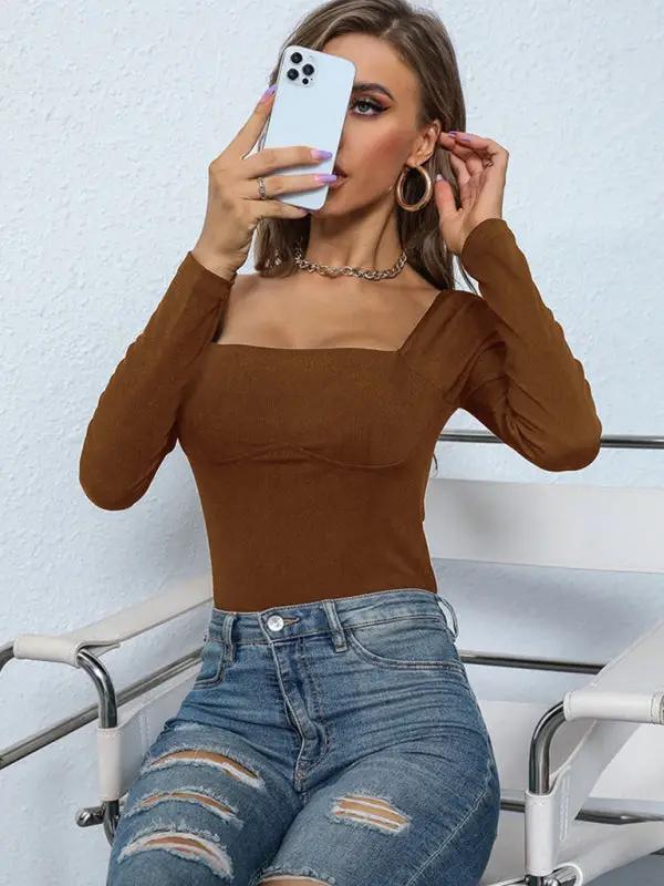 Woman in brown jumpsuit taking a selfie