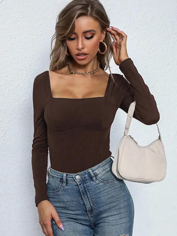 Dark brown ribbed jumpsuit styled with a white bag