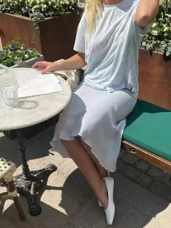 Woman in printed top and skirt at cafe