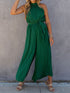 Elegant green pleated jumpsuit with halter neck