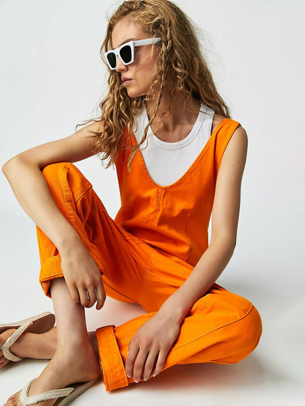 Bright orange V-neck jumpsuit with sunglasses