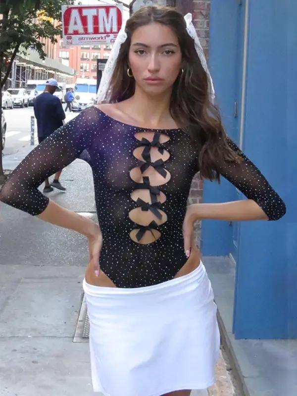 Model in black jumpsuit with white skirt