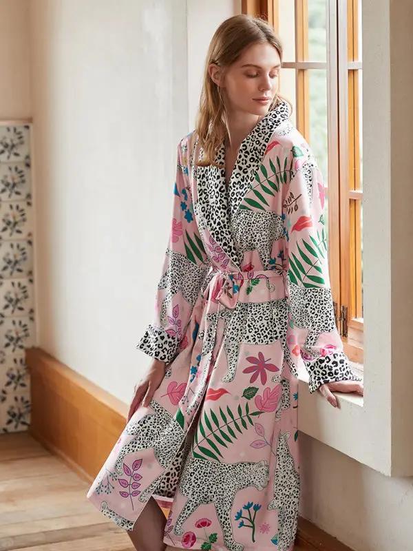 Woman by window in animal print bathrobe