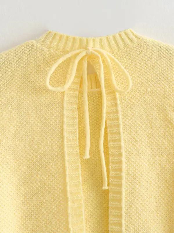 Close-up of yellow knitted vest top with lace-up back