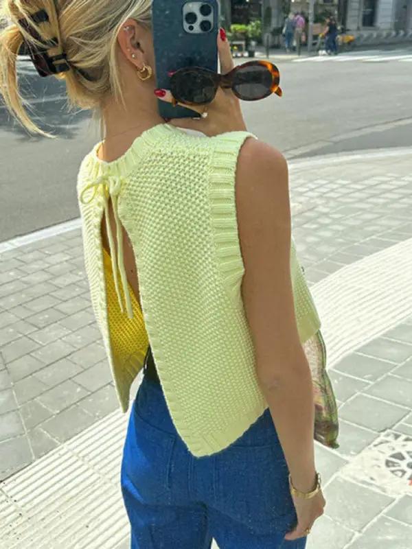 Back view of woman in yellow lace-up backless vest top