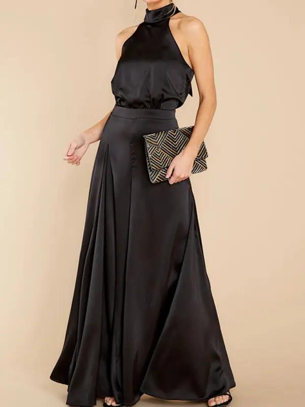 Black halter-neck wide-leg jumpsuit with clutch, front view