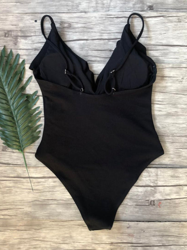 Back view of black ruffled one-piece swimsuit