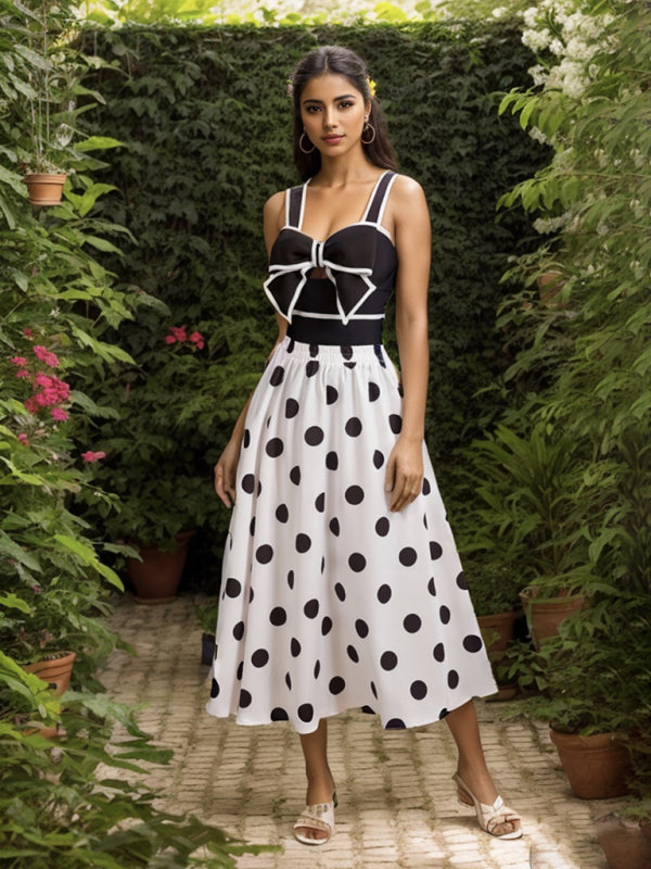 Black swimsuit with polka dot skirt in garden