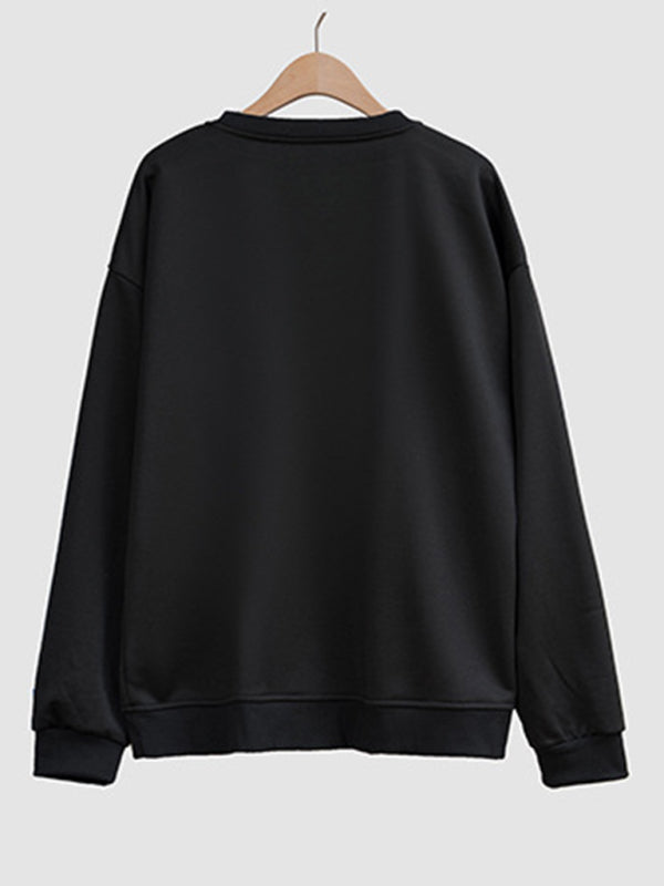 Black sweatshirt on hanger, round neck design.