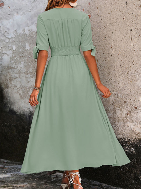 Back view of green V-neck belted midi dress with tie sleeves.