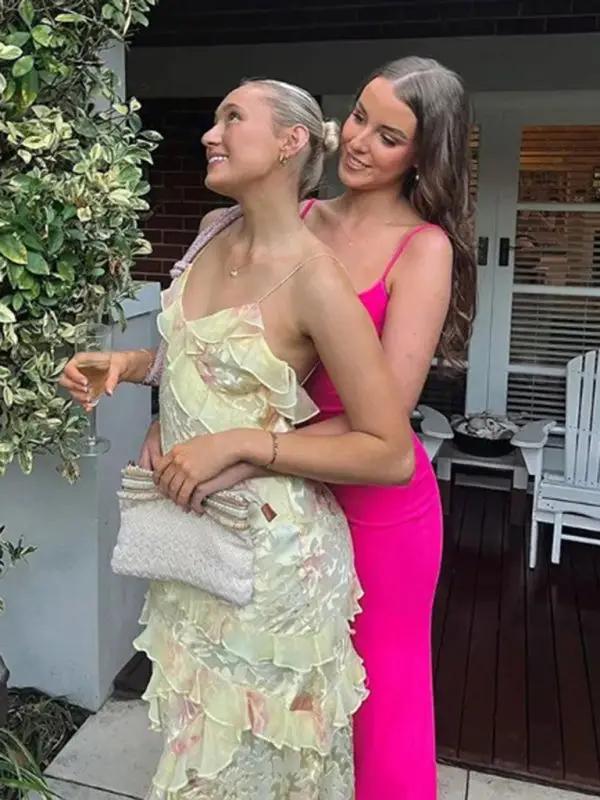 Two women in elegant dresses at a party