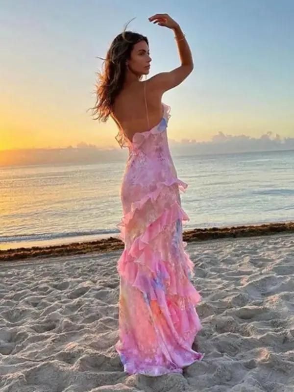 Woman posing in wavy edge suspender dress at sunset