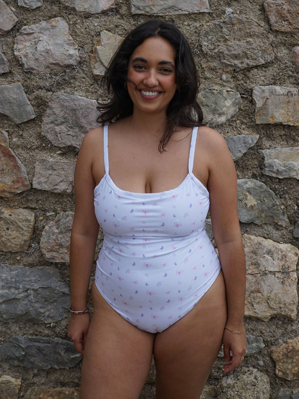 Woman in white printed backless sports swimsuit smiling