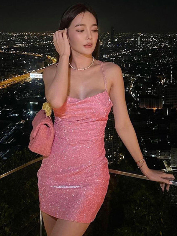 Woman in pink glittery dress with city view