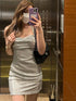 Woman in silver glittery backless dress in elevator