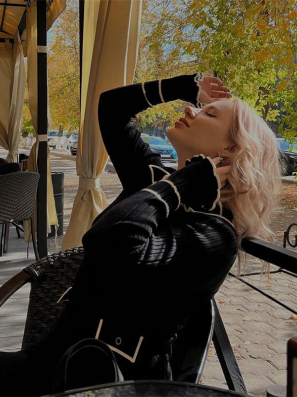 Woman in black French dress relaxing outdoors