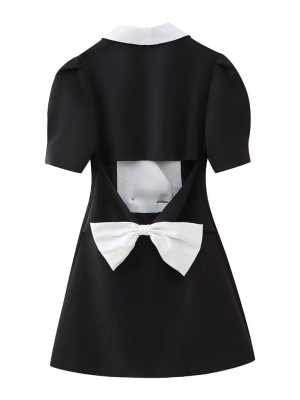 Back view of black dress with white bow
