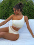 Model wearing white slanted shoulder bikini with high waist