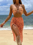 Orange cashew print bikini with mesh skirt on beach