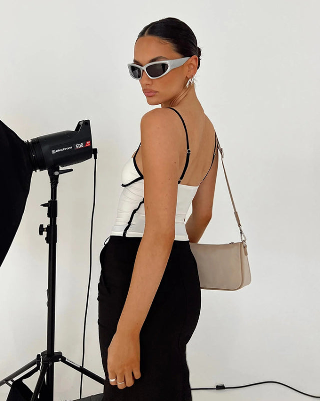 Side view of white camisole with black trim