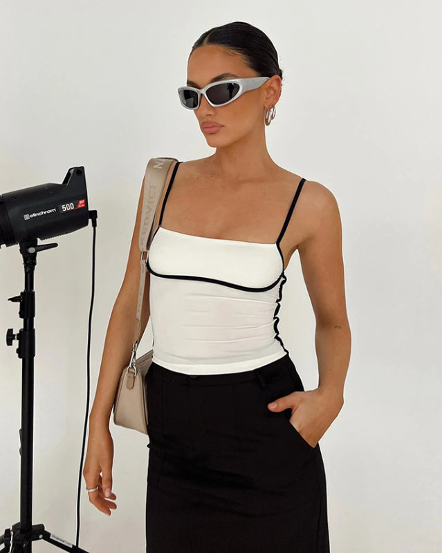 Model in white camisole and sunglasses