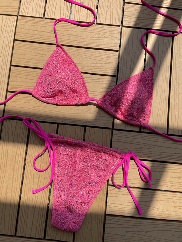 Pink glitter strap triangle bikini on wooden surface