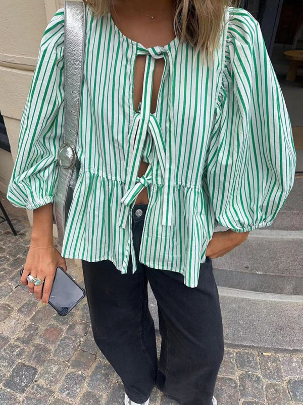 Close-up of striped blouse with silver bag