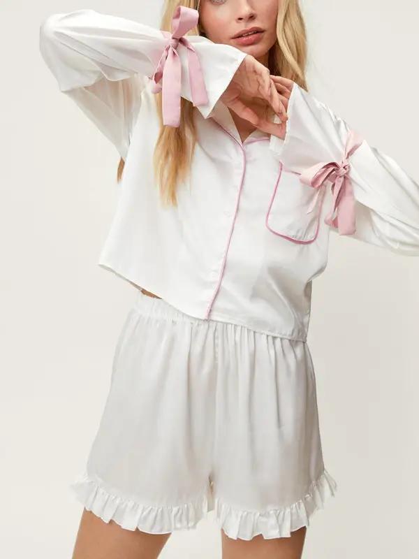 White lapel pajama set with pink bows and ruffle shorts