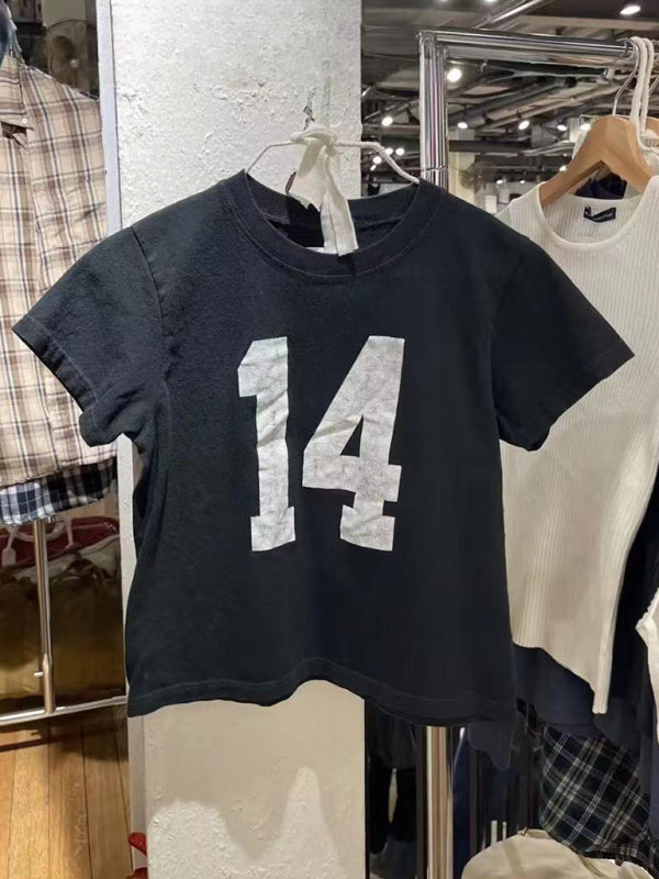 Black distressed T-shirt with number 14 displayed in store