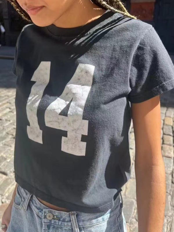 Person wearing black distressed T-shirt with number 14