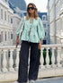 Green striped puff sleeve shirt with black wide-leg pants
