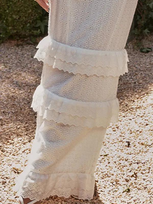 Close-up of white dress fabric and ruffle details
