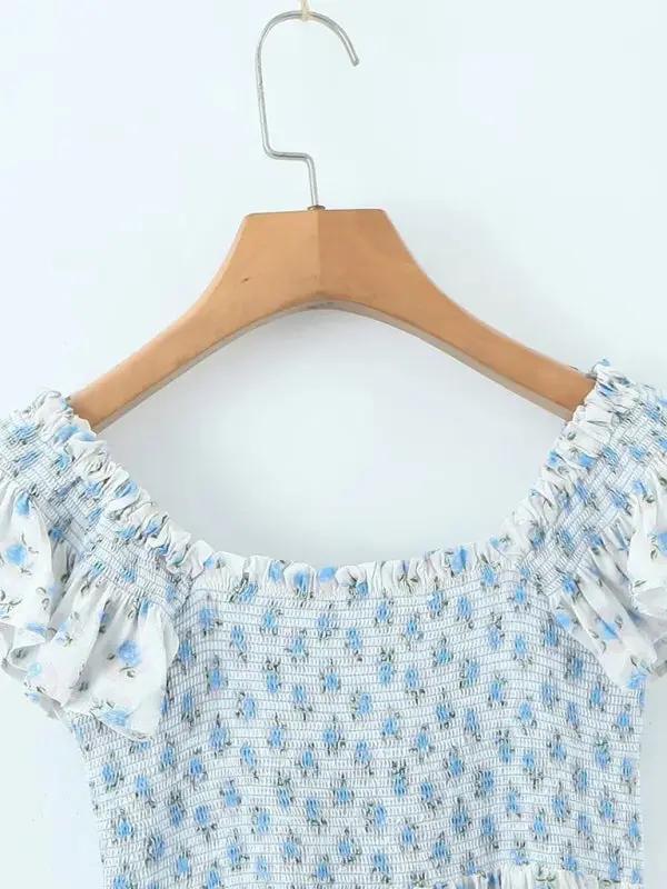 Dress on hanger showing flying sleeves and pleated neckline