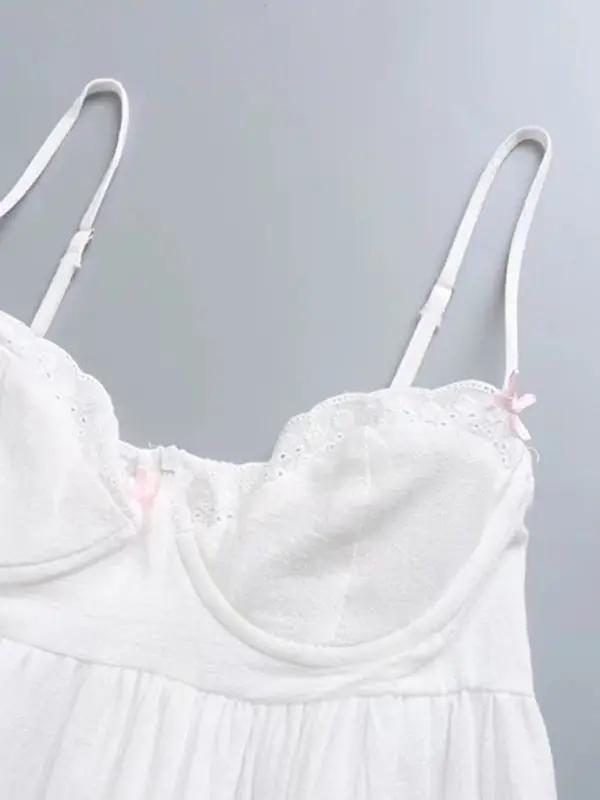 Front view of lace splicing on white suspenders dress