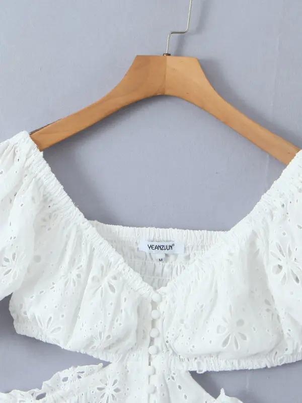 White lace dress on hanger with off-shoulder design
