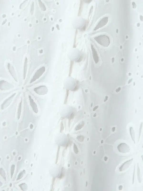 Detail of buttons on white lace dress
