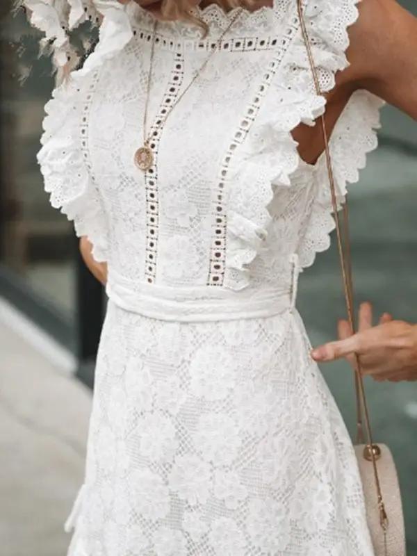 Close-up of white lace dress with intricate embroidery