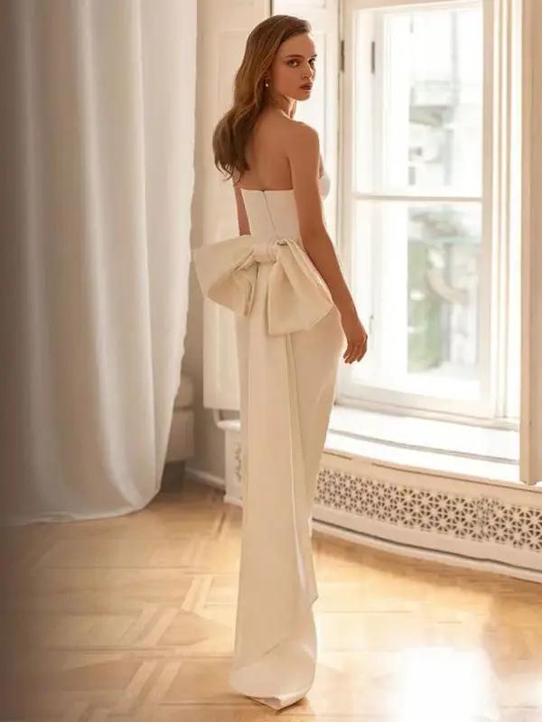 Back view of white tube top dress with bow accent
