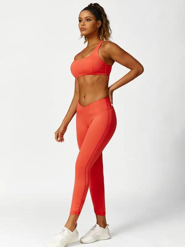 Full body view of orange activewear set, leggings and top