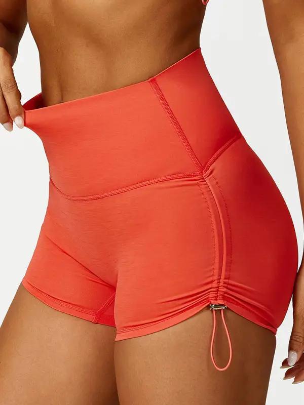 Orange high-waisted yoga shorts with drawstring
