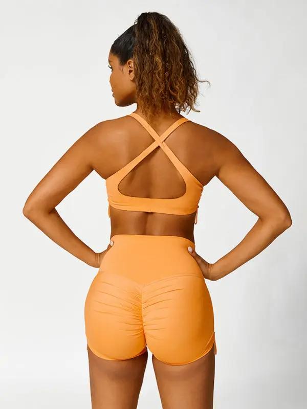 Orange high-waisted yoga shorts, back view