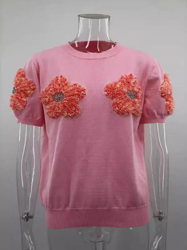 Pink sweater with contrasting flower design, round neck.
