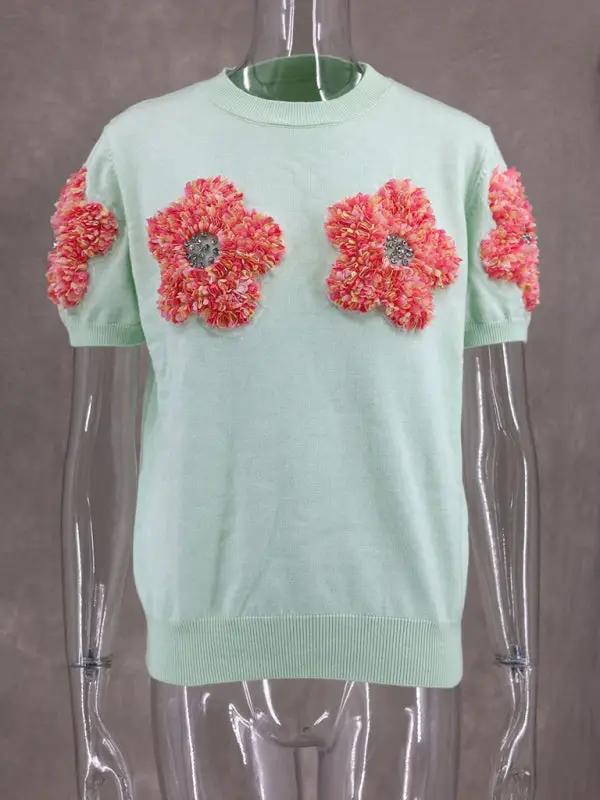 Front view of sweet pink sweater with floral design.