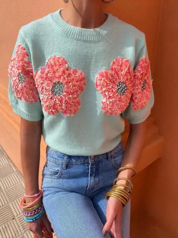 Sweet pink sweater with contrasting flower design, round neck.