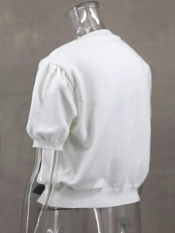 Side view of white short-sleeved sweater on mannequin