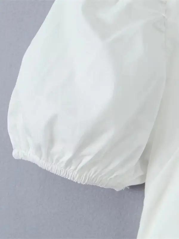 Close-up of puff sleeve on white lace shirt