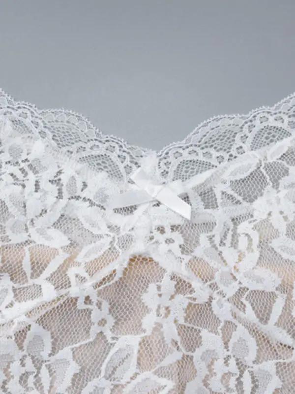 Close-up of lace fabric with bow detail on dress